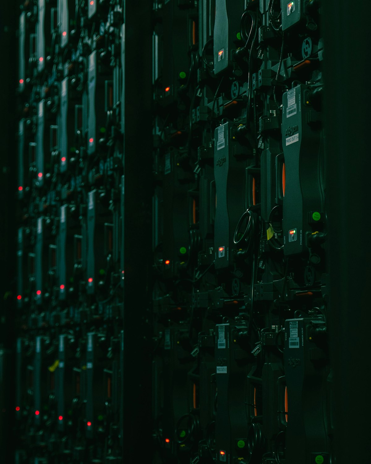 Rows of server racks in a dark data-centre hall